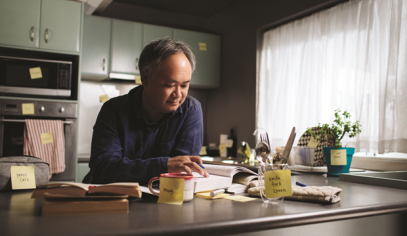 person working on a desk with objects