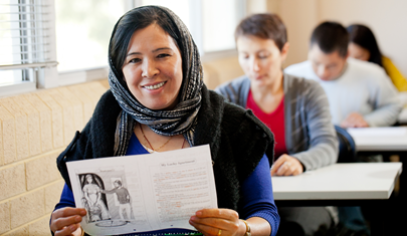 person with a paper showing it on camera
