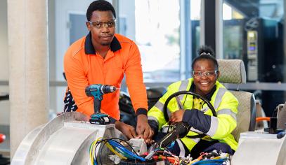 male and female electricians with equipment