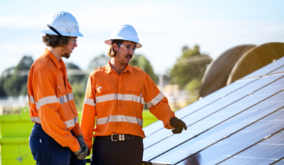 two people pointing at solar panels