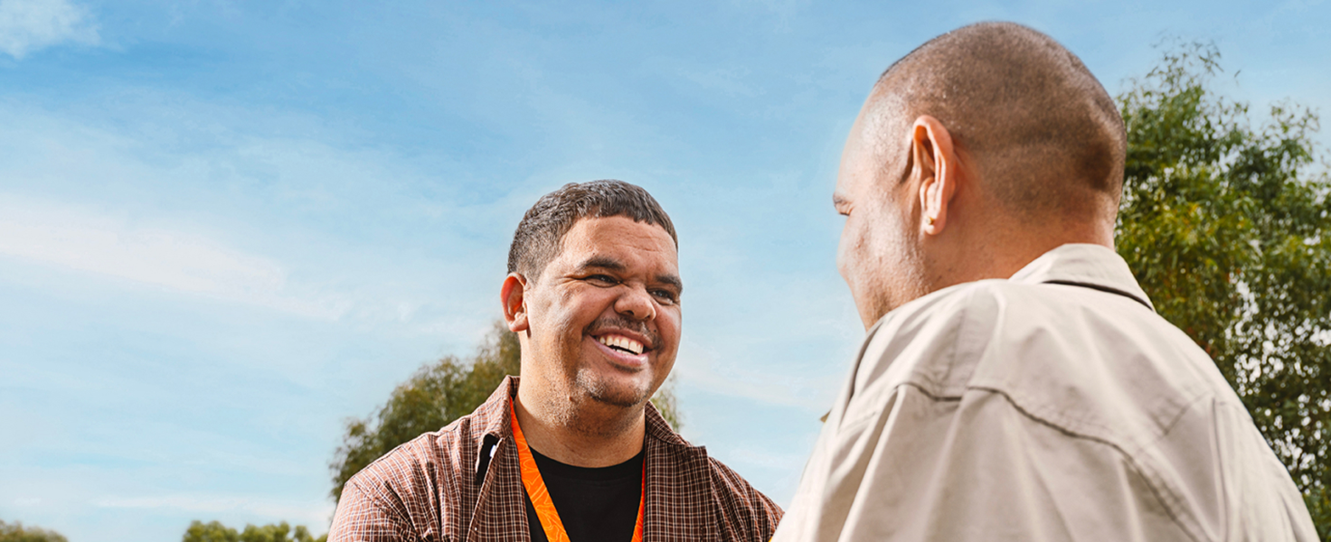 male community worker with another person outdoors