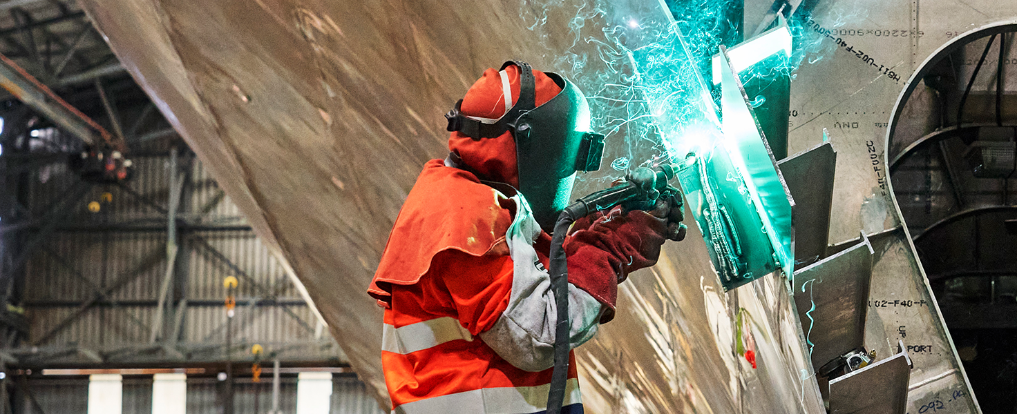 male metal fabricator wearing protective outfit