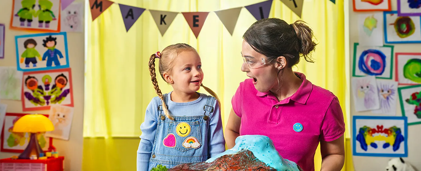 female child care worker with child in artwork and fun setting