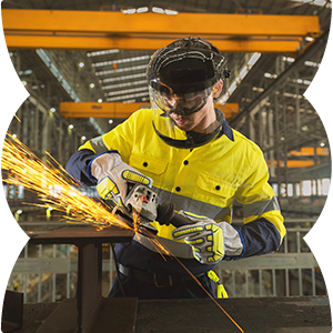 male metal fabricator with protective gear and sparks