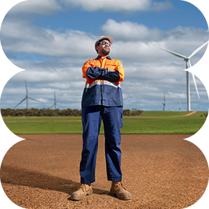 male electrician in protective gear with wind turbine